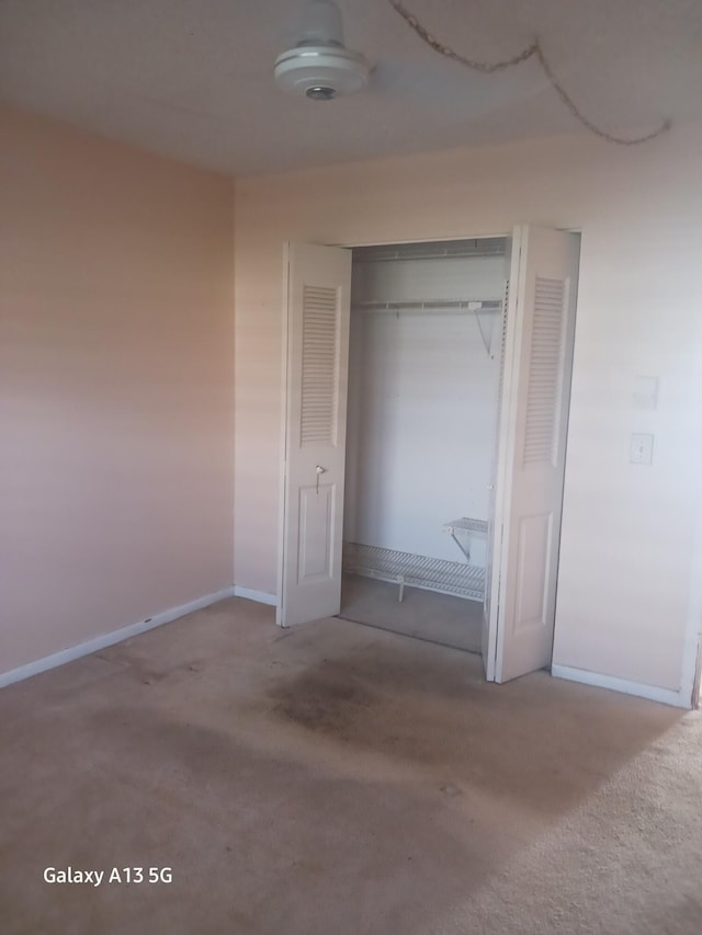 unfurnished bedroom with carpet and a closet