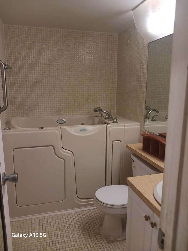 bathroom with vanity, toilet, a tub, and tile patterned flooring