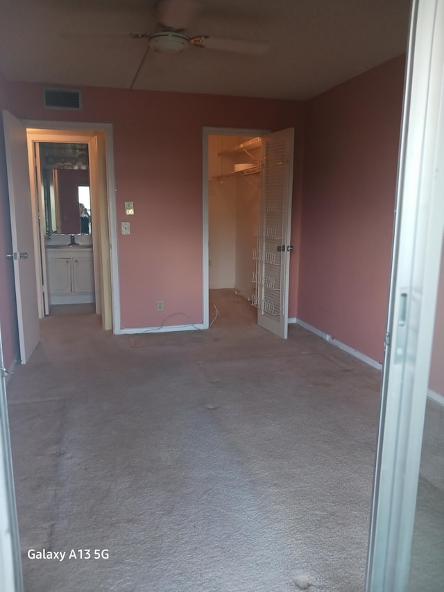 empty room featuring sink and light colored carpet