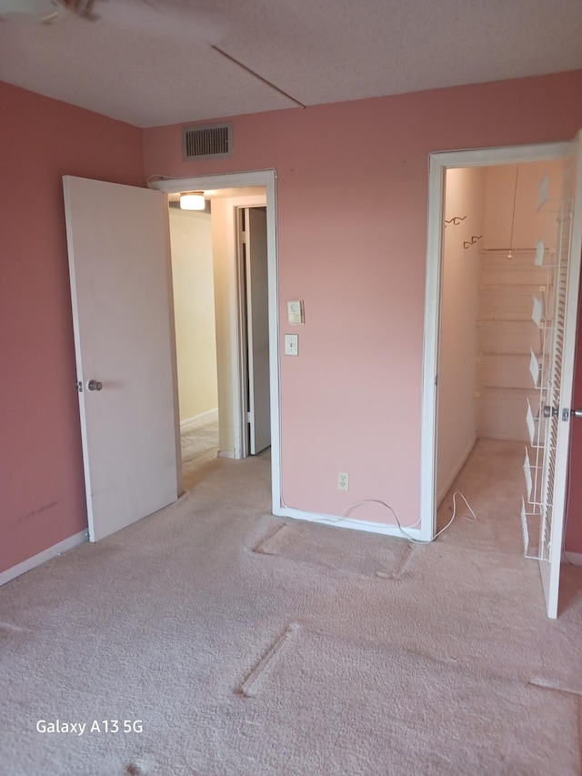 110 Northampton Unit F, West Palm Beach, FL 33417 - unfurnished bedroom featuring carpet floors and visible vents