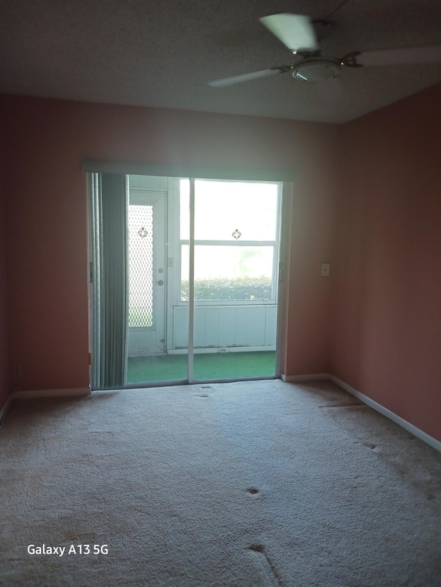 110 Northampton Unit F, West Palm Beach, FL 33417 - carpeted empty room featuring baseboards and ceiling fan
