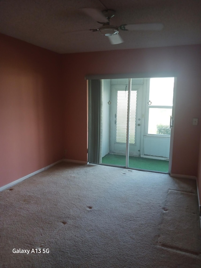 empty room with carpet and ceiling fan