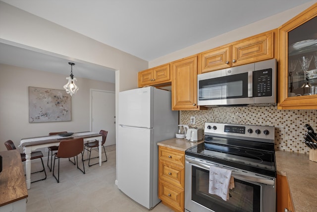 kitchen with pendant lighting, decorative backsplash, and stainless steel appliances