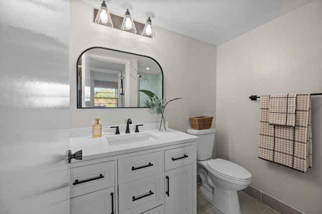 bathroom with tile patterned floors, vanity, and toilet