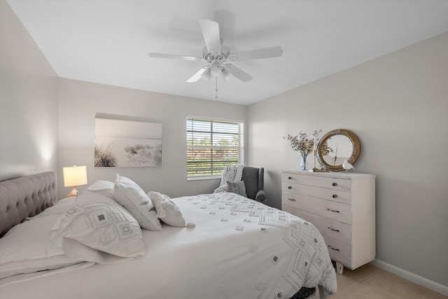 tiled bedroom featuring ceiling fan