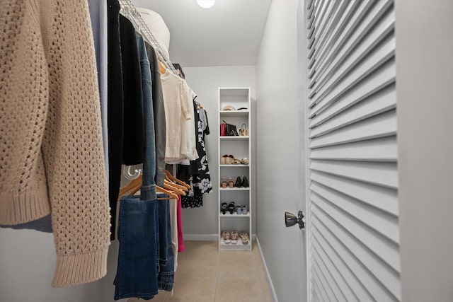 spacious closet with light tile patterned floors