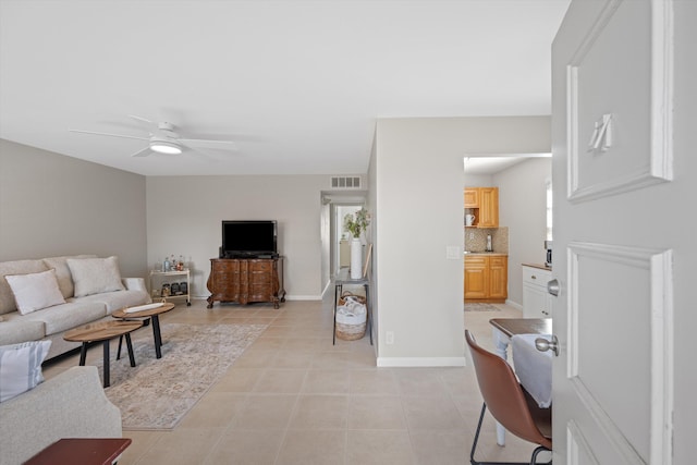 tiled living room featuring ceiling fan