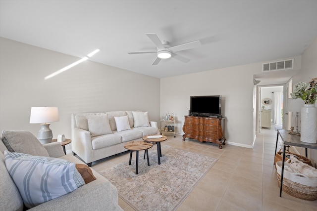 tiled living room with ceiling fan