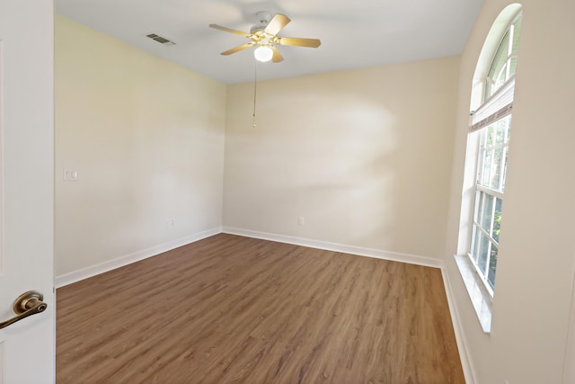 empty room with ceiling fan and wood-type flooring