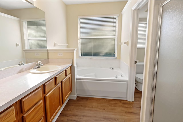 full bathroom with vanity, separate shower and tub, toilet, and wood-type flooring