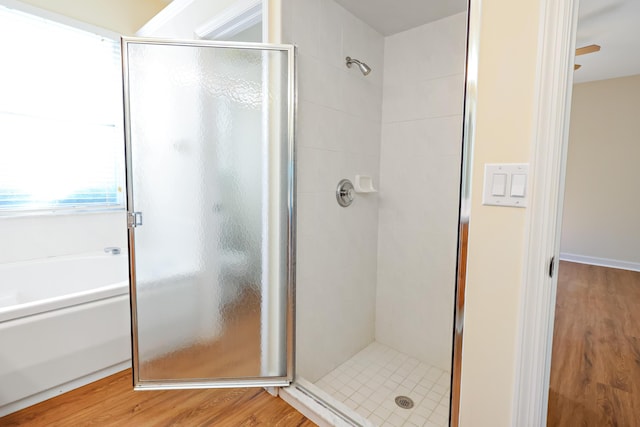 bathroom featuring wood-type flooring and an enclosed shower