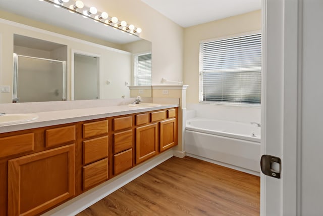 bathroom featuring shower with separate bathtub, vanity, and hardwood / wood-style flooring