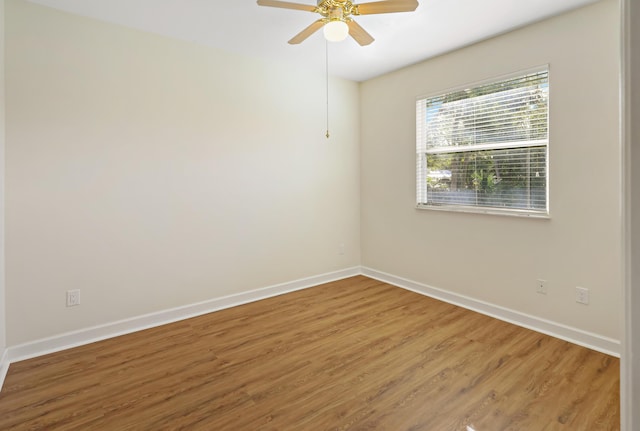 unfurnished room with hardwood / wood-style floors and ceiling fan