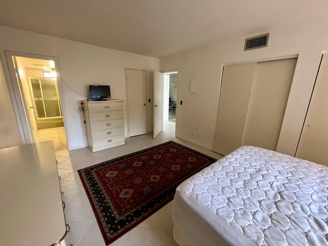 tiled bedroom with a closet