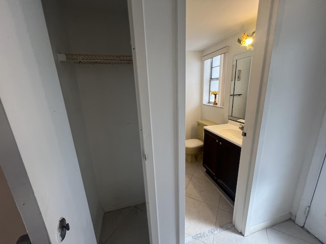 bathroom with tile patterned flooring, vanity, and toilet