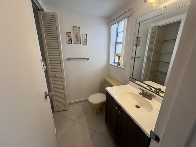 bathroom featuring toilet, vanity, and tile patterned floors