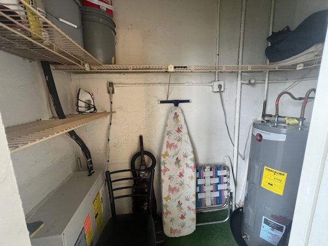 utility room featuring water heater