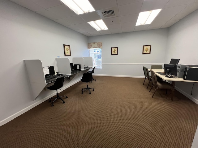 carpeted office with a drop ceiling