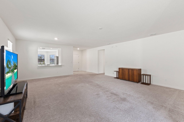 unfurnished living room featuring light carpet