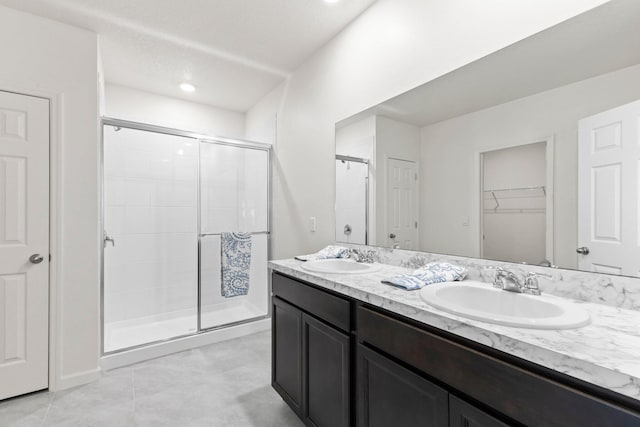 bathroom featuring vanity, tile patterned floors, and walk in shower