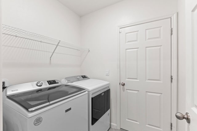 clothes washing area featuring washing machine and clothes dryer