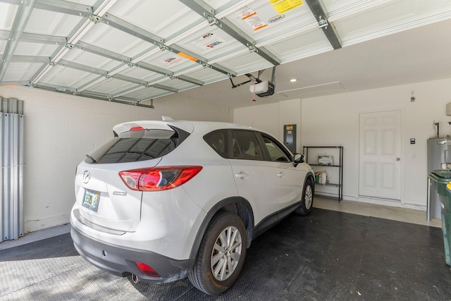 garage with a garage door opener and electric panel