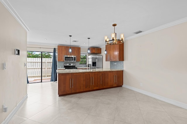 kitchen with appliances with stainless steel finishes, light stone countertops, backsplash, kitchen peninsula, and pendant lighting