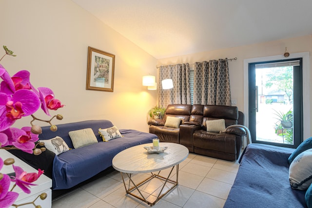 living room featuring lofted ceiling and light tile patterned floors