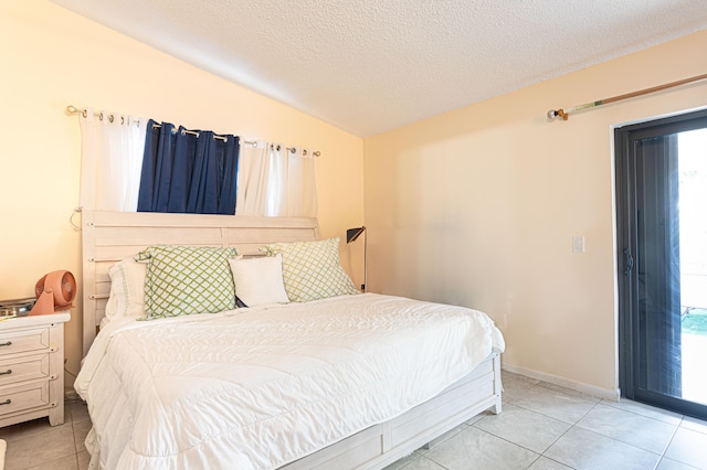 tiled bedroom with a textured ceiling and lofted ceiling