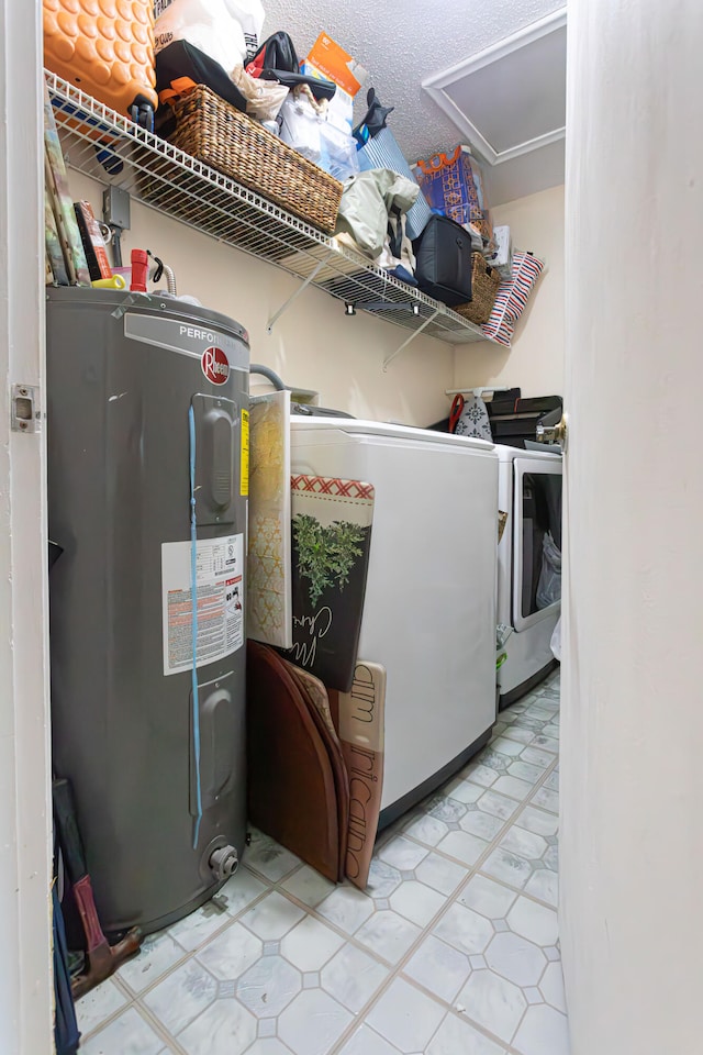 laundry area with independent washer and dryer, electric water heater, a textured ceiling, and light tile patterned floors