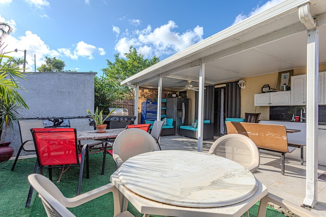 view of patio with a grill and ceiling fan