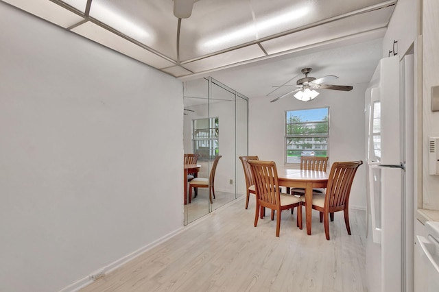 dining area featuring ceiling fan and light wood-type flooring