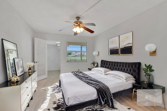 bedroom with light wood-type flooring and ceiling fan