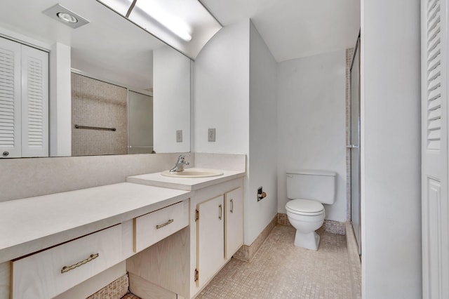 bathroom with tile patterned flooring, vanity, a shower with door, and toilet