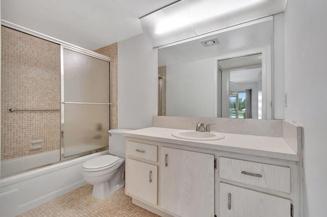 full bathroom featuring tile patterned floors, vanity, toilet, and shower / bath combination with glass door