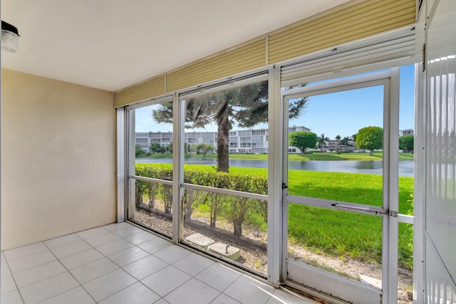 unfurnished sunroom featuring plenty of natural light and a water view