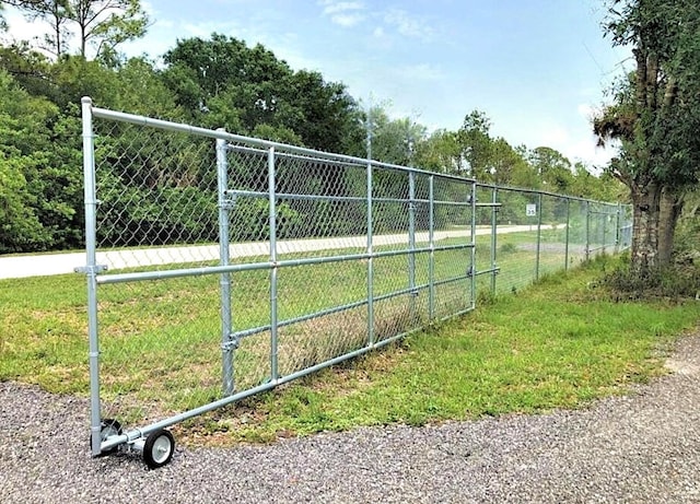 view of gate featuring a lawn