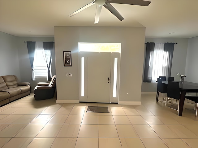 foyer with light tile patterned floors and ceiling fan