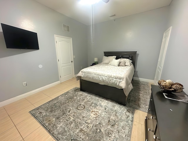 tiled bedroom featuring ceiling fan