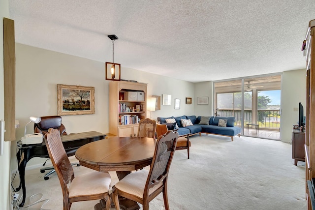 dining space featuring a textured ceiling and light carpet