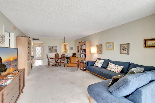 living room with light carpet and a textured ceiling