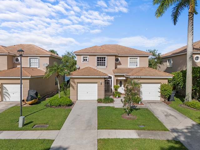 mediterranean / spanish home with a front yard and a garage