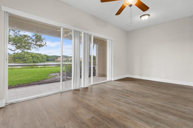 empty room with hardwood / wood-style floors and ceiling fan