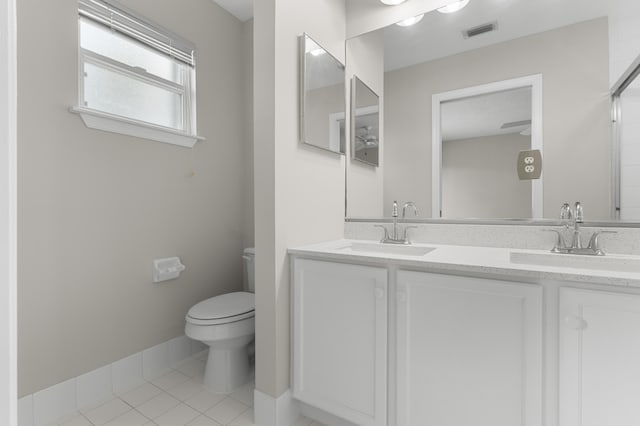 bathroom featuring toilet, vanity, and tile patterned floors