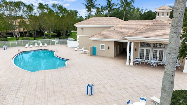 view of pool with french doors and a patio area