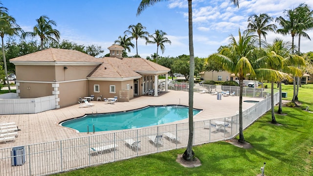 view of swimming pool featuring a yard and a patio area