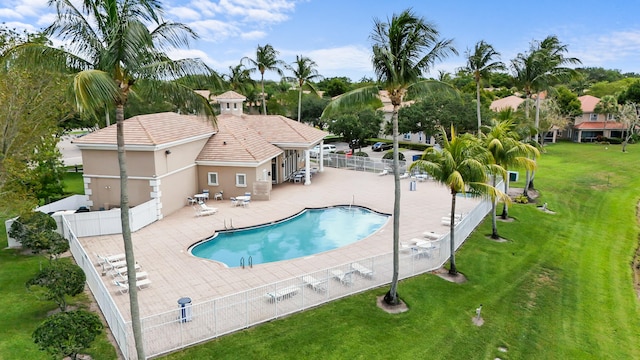 view of pool with a patio area and a lawn