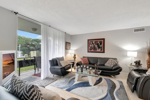 tiled living room with a textured ceiling