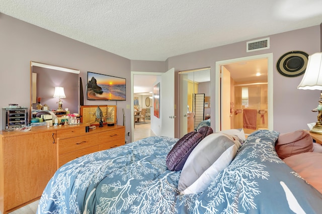 bedroom with a textured ceiling and a closet