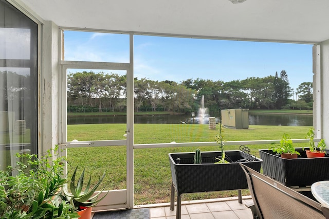 sunroom / solarium with plenty of natural light and a water view